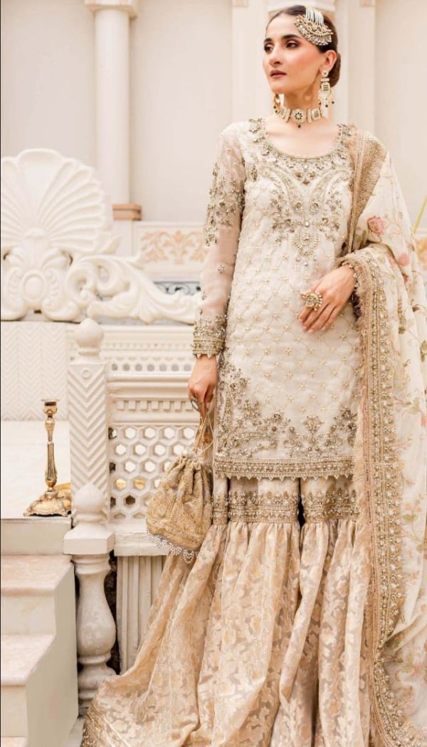 Unstitched Maria B Bridal dress in ivory gold color.