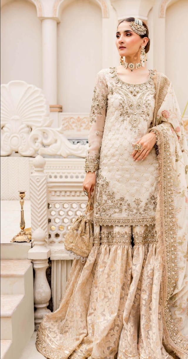 Unstitched Maria B Bridal dress in ivory gold color.